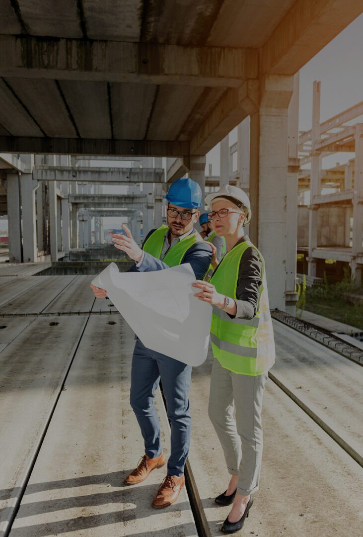 Construction workers reviewing blueprints on-site