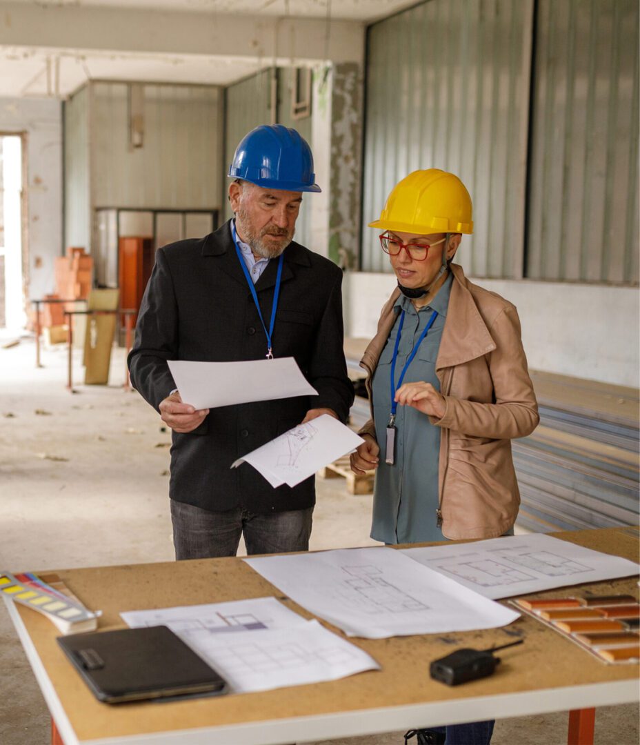 Construction professionals analyzing project documents.