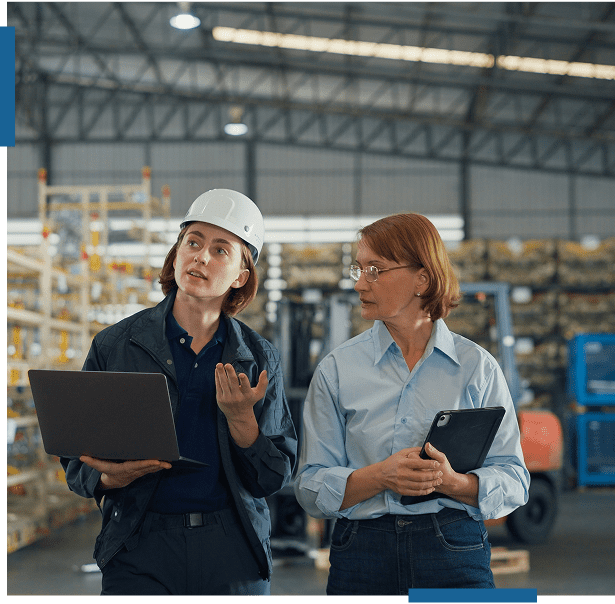 Two professionals discussing work in a warehouse.