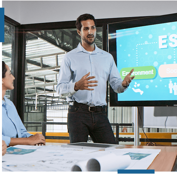 A man presenting data to colleagues in a modern office meeting.